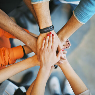 Closeup,Of,Stack,Of,Hands.,Young,College,Students,Putting,Their