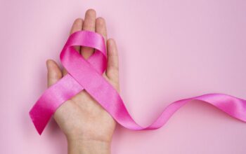 close-up-breast-cancer-concept-with-ribbon-scaled